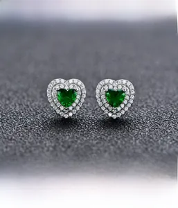 Close-up of heart-shaped emerald earrings with dual halo micro-pave setting on S925 silver