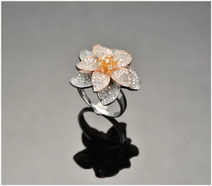 Detailed view of layered flower ring with rose gold petals and cubic zirconia stones