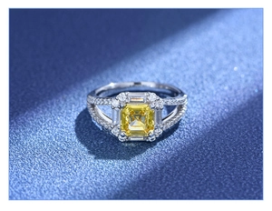 Macro view of Asscher cut yellow gemstone ring with diamond halo on navy background