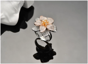 Macro detail of a 925 silver flower ring with rose gold petals and cubic zirconia
