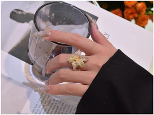 Close-up of a leaf-shaped cocktail ring with pave-set zircons on a model's hand
