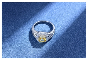 Macro shot of 925 silver ring featuring a yellow square cut gemstone and side hollow design