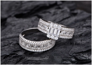 Macro shot of 925 silver ring set with emerald-cut cubic zirconia on black charcoal background