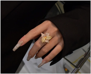 Detailed macro of a luxury three-tone floral ring with pavé set zircon on a hand