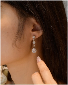 Close-up of S925 silver pear-shaped drop earrings with sparkling cubic zirconia stones