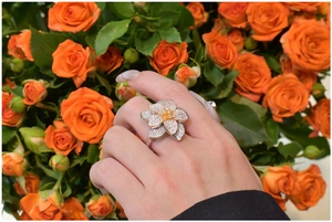 Detailed view of an oversized flower ring with zircon petals and yellow gemstone center