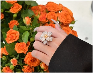 Close-up of S925 silver flower ring with zircon petals and yellow gemstone center