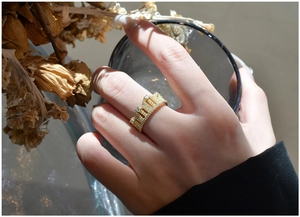 Detailed view of a gold-plated crown ring with sparkling pave-set cubic zirconia stones