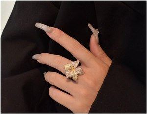 Macro detail of a large nature-inspired multi-tone leaf ring with pavé diamond setting