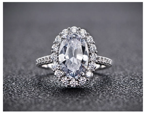 Macro shot of oval-cut pink high-carbon diamond ring with halo pavé setting in S925 silver
