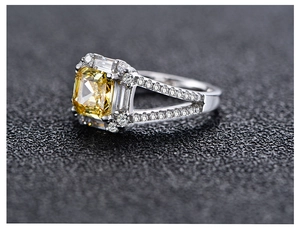 Macro view of Radiant cut yellow gemstone ring with luxury split shank detail