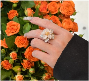 Detailed view of layered floral ring with pavé crystals and mixed metal finish