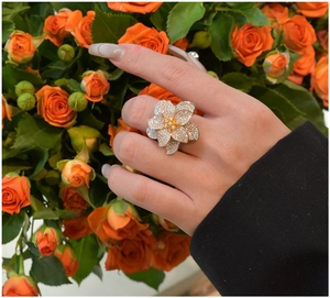 Detailed macro view of S925 silver floral ring with tricolor plating and pavé cubic zirconia