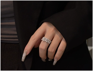 Macro shot of silver crown ring with cubic zirconia stones on model finger