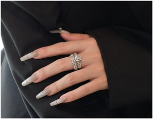 Detail of S925 silver double layer ring set with rectangle diamonds on a female hand