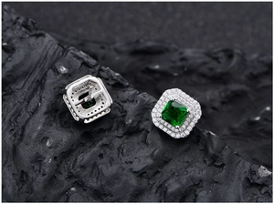 Macro detail of square emerald earrings in S925 silver with double halo pave setting