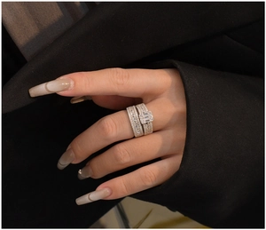 Close-up of 925 silver ring set with rectangular zircon worn against black fabric