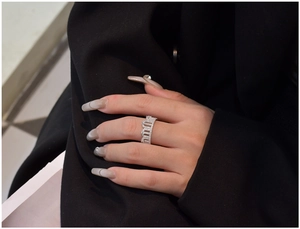 Detailed close-up of a 925 silver crown ring with pave-set zircons on a finger