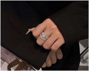 Detailed close-up of a three-piece 925 silver ring set with emerald cut cubic zirconia