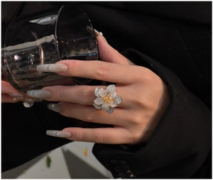 Detailed close-up of a tricolor plated floral ring with sparkling zircon stone petals