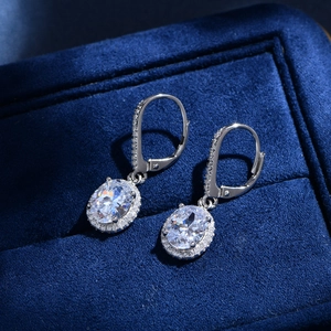 Elegant 925 sterling silver halo earrings with oval cut main stones in a velvet box