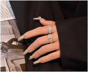 Detailed view of 925 silver rings with baguette cubic zirconia on model's hand