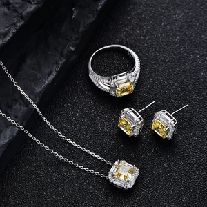 925 silver jewelry set with radiant cut yellow diamonds on black stone background