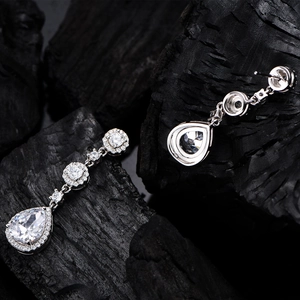 Pear-cut crystal teardrop earrings in S925 sterling silver on black charcoal background