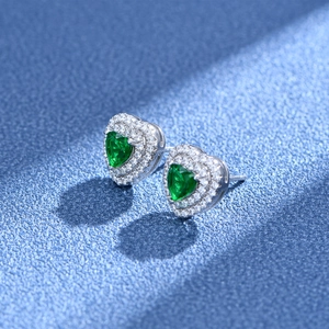 Classic heart-shaped emerald green stud earrings in silver with double diamond halo setting