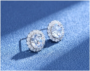 Macro view of classic S925 silver halo stud earrings with round-cut sparkling crystals