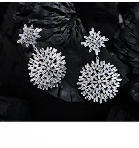 Macro view of baguette-cut crystals in snowflake earrings with platinum texture finish