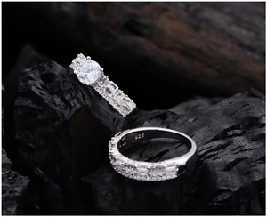 Macro shot of 925 sterling silver stamp and sparkling cubic zirconia bridal ring set