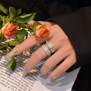 925 silver ring set with emerald cut zircon and pavé stones on a floral background