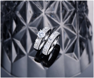 Macro shot of silver wedding ring set with brilliant round and baguette cut stones