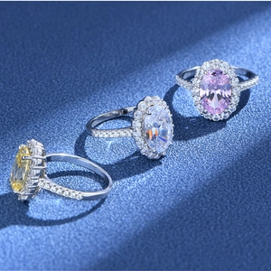 Three oval halo rings in pink, white, and yellow with micro-pave silver bands