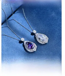 Macro detail of pear-cut purple zircon pendant with micro-paved diamonds on silver chain