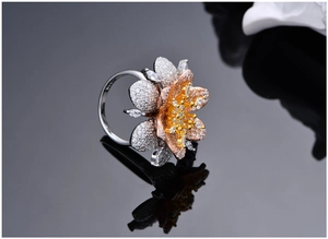 Close-up of S925 silver stamp on luxury micro-paved zircon floral ring with gold stamens