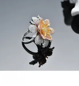 Macro detail of multi-layer plated flower ring with champagne cubic zirconia stones