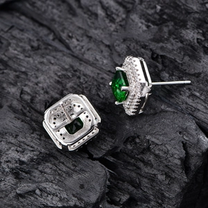 S925 sterling silver square emerald halo stud earrings on charcoal wood background