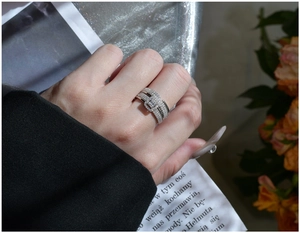 Macro shot of silver multi-layer micro-pave ring set with a rectangular buckle detail