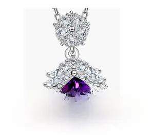 Detailed macro view of pear-shaped purple gemstone pendant with brilliant accent stones