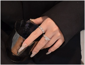 Macro shot of S925 silver stacked rings with cubic zirconia stones on model's hand