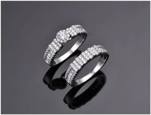 Macro view of S925 silver snowflake rings with micro-pave diamonds on dark mirror