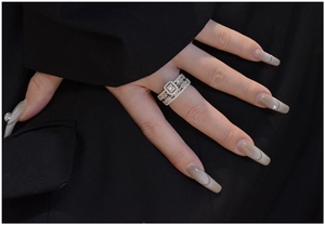 Detailed view of S925 silver stacked rings with rectangular cut main stone on black fabric