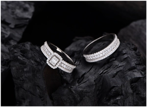 Macro shot of S925 silver rings with rectangle cut zircon on dark charcoal stone