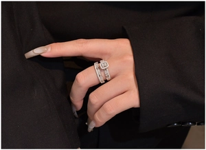 Macro shot of S925 silver wedding ring set with princess cut main stone on black suit fabric