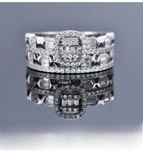 Macro shot of silver-plated wide band ring with emerald-cut crystals and pavé cubic zirconia