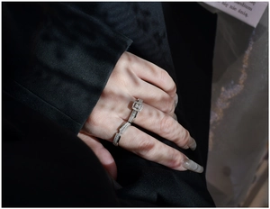 Detail of square halo silver ring set with zircon micro-paving on a model's hand
