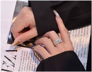 Close-up of elegant 925 silver wedding ring set with round and baguette cut zirconia