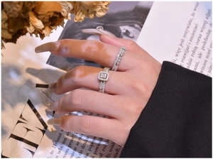 Detail view of S925 sterling silver stacked rings with eternity band and square crystals